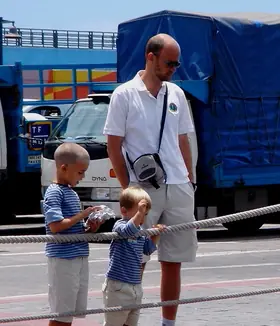 TíoCharly con sus dos hijos pequeños en un puerto